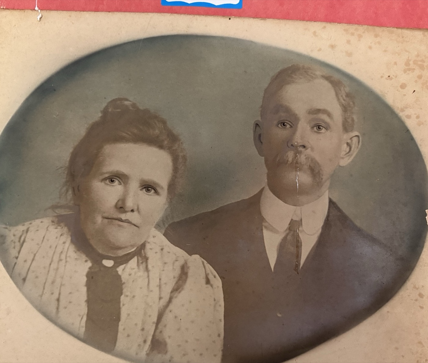 An antique oval studio portrait of an early Tucker couple